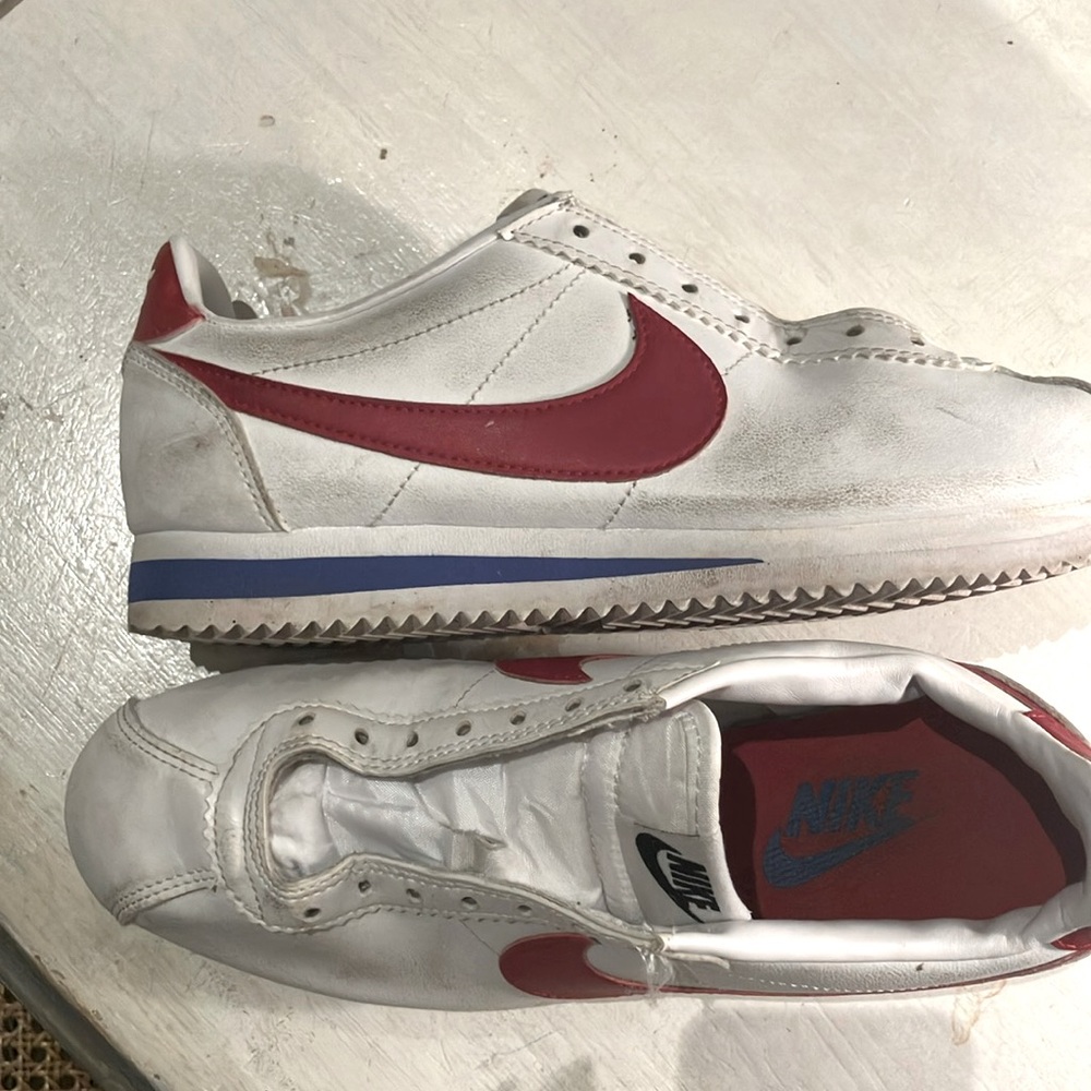 Classic Cortez  worn slightly scuffed white with red swish Nike sneaker
